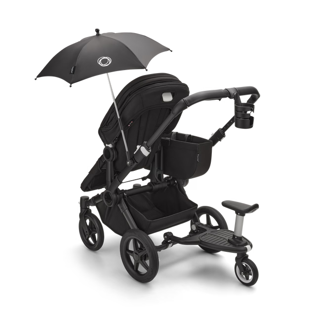 Bugaboo Carrinho Donkey 5 Twin – Capota Midnight Black, tecidos Grey Melange e estrutura preta, design lado a lado.