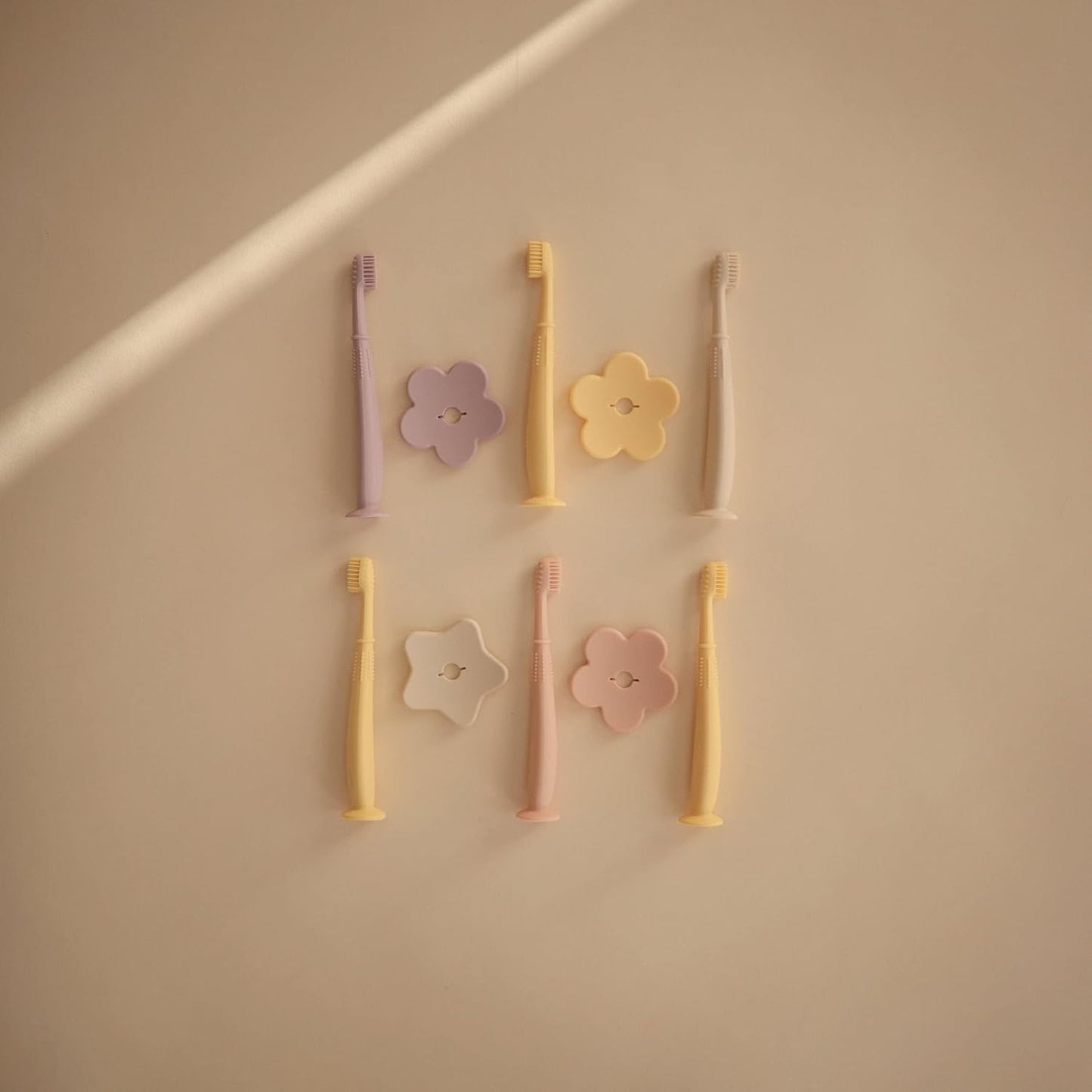 Mushie Escova de dentes de treinamento em silicone, para bebês e crianças pequenas, com base de sucção para fácil armazenamento e treinamento, material: silicone de qualidade alimentar, design de flor (narciso claro).