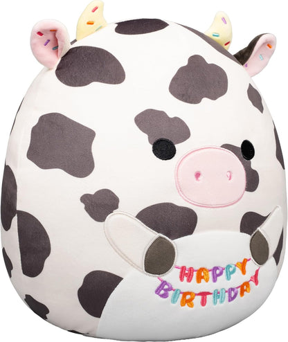 Squishmallows Original de 12 Polegadas – Colin, a Vaca Malhada, Segurando Placa de Aniversário – Pelúcia Oficial Jazwares (Tamanho Médio)