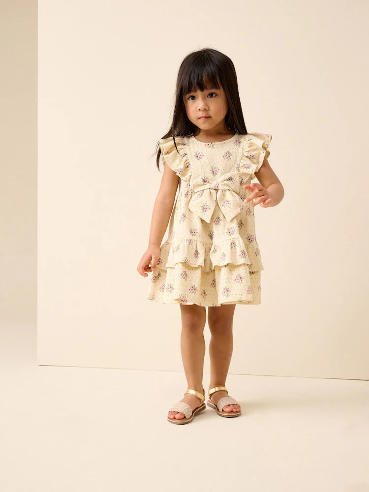 |Girl| Vestido De Verão Cor Creme Sem Mangas Com Detalhe De Laço e Babados (3 meses a 7 anos)
