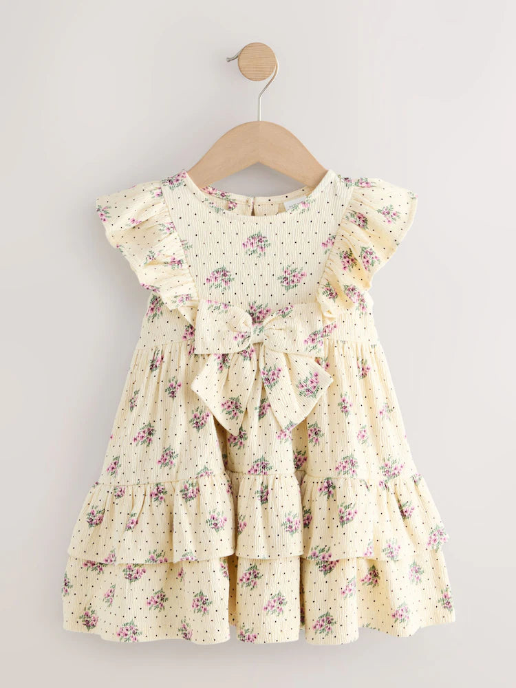 |Girl| Vestido De Verão Cor Creme Sem Mangas Com Detalhe De Laço e Babados (3 meses a 7 anos)