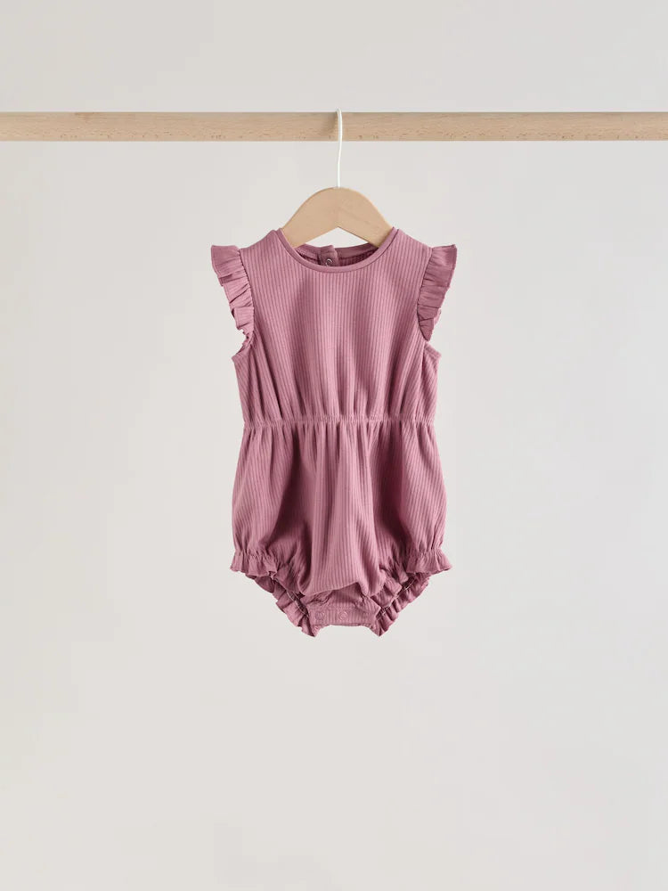 |BabyGirl| Conjunto Com 4 Macacões De Bebê Rosa com Estampa De Bolinhas e Listras Em Tons de rosa e babados nos ombros.