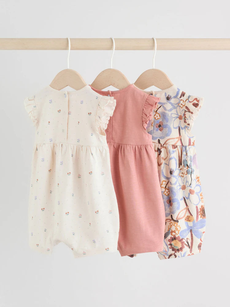 |BabyGirl| Conjunto Com 3 Macacões Florais Lilás e Cru Com Babados Nos Ombros