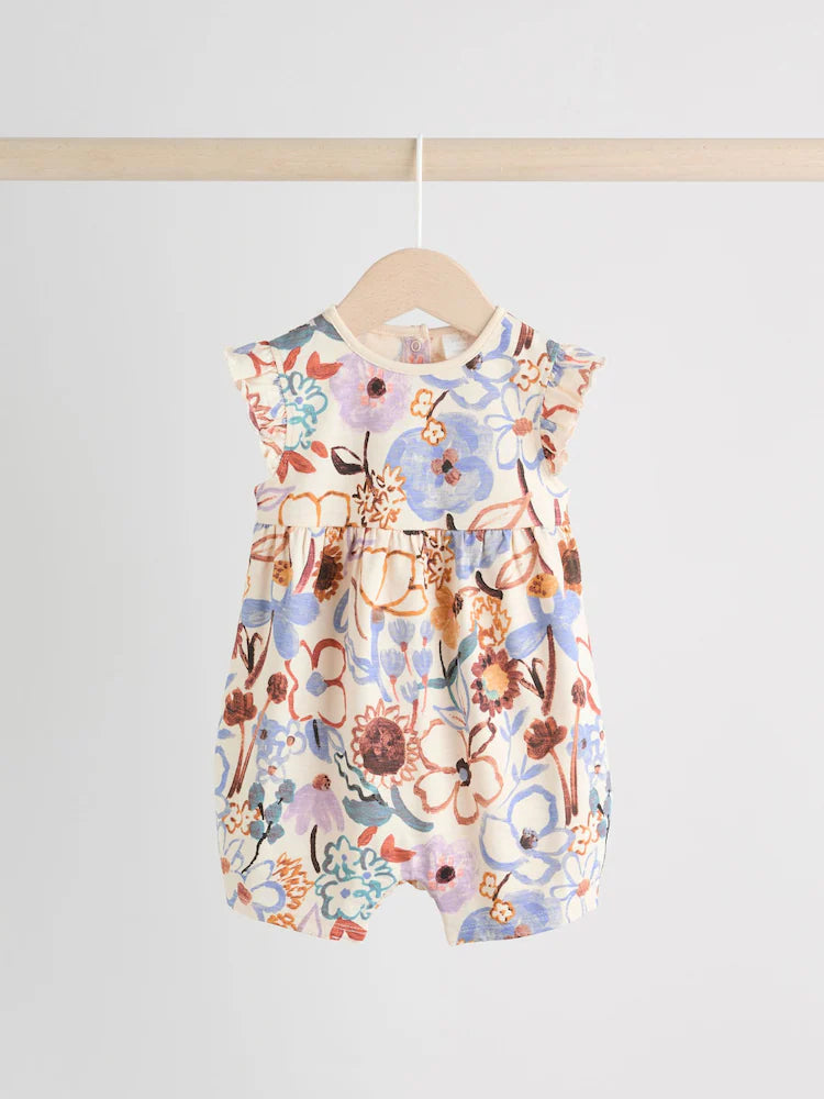 |BabyGirl| Conjunto Com 3 Macacões Florais Lilás e Cru Com Babados Nos Ombros