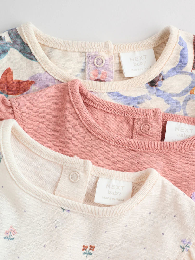 |BabyGirl| Conjunto Com 3 Macacões Florais Lilás e Cru Com Babados Nos Ombros