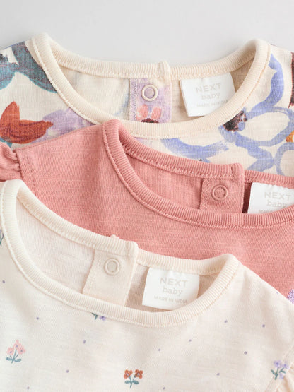 |BabyGirl| Conjunto Com 3 Macacões Florais Lilás e Cru Com Babados Nos Ombros