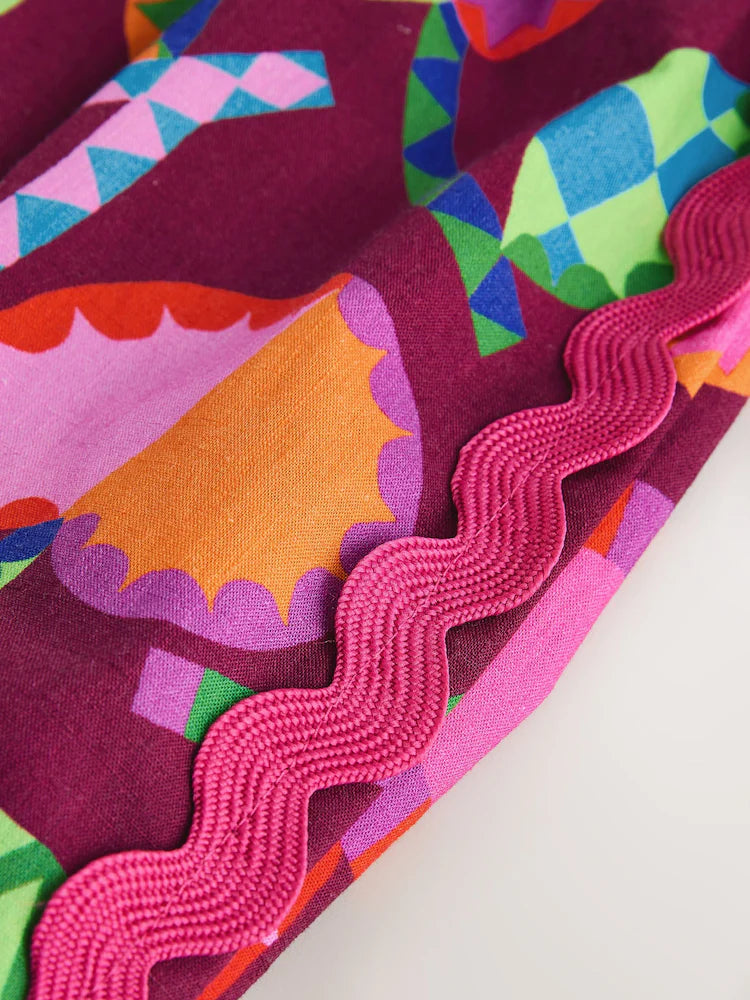 |Girl| Macacão Curto Estampado Em Tons De Roxo e Vermelho (3 meses a 7 anos)